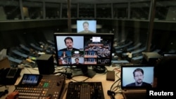 FILE - Edward Snowden speaks via video link as he takes part in a round table on the protection of whistleblowers at the Council of Europe in Strasbourg, France, March 15, 2019.