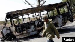 The wreckage of a bus that was burnt in a blockade set by members of the Santa Rosa de Lima Cartel to repel security forces during an anti-fuel theft operation is pictured in Santa Rosa de Lima, in Guanajuato state, Mexico, March 6, 2019. 