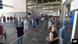 Voters wait in line to cast their ballots in the Kentucky primary at Kroger Field in Lexington, Kentucky, June 23, 2020.