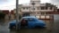 A man tries to start the engine of a vintage car in a flooded street in Havana, Cuba, January 23, 2017. 
