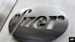 FILE - This file photo shows the Pfizer company logo at the company's headquarters in New York. 