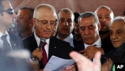 Palestinian Prime Minister Rami Hamdallah speaks during a press conference on his arrival to the Palestinian side of the Beit Hanoun border crossing in the northern Gaza Strip, Oct. 2, 2017. 