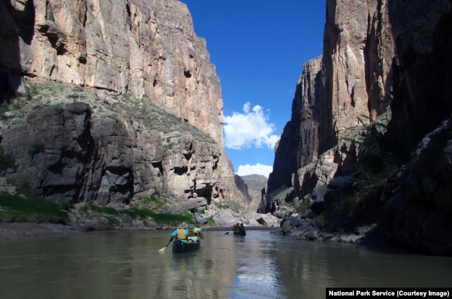 People are seen boating through Mariscal Canyon in Big Bend National Park