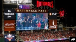 Images of President Donald Trump and first lady Melania Trump, accompanied by Republican lawmakers, are seen on an outfield scoreboard during a Salute to the Military during Game 5 of the World Series in Washington D.C., Oct. 27, 2019.
