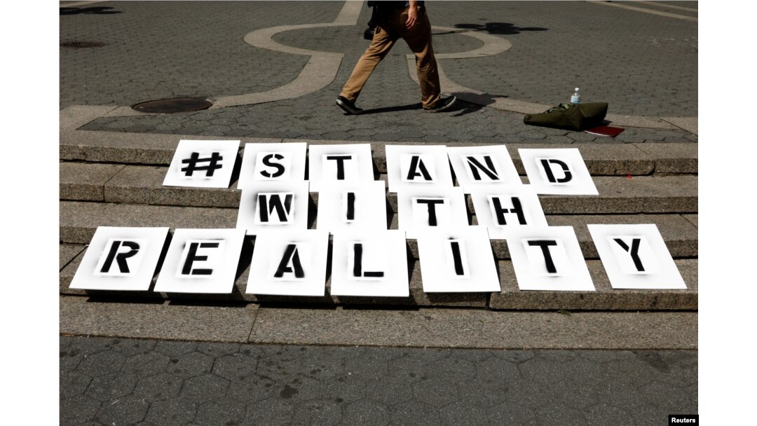 A sign used by a small group of demonstrators rests on steps during a demonstration to support intelligence contractor, Reality Leigh Winner, after she was charged with leaking classified documents, June 7, 2017.