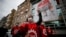 A demonstrator, wearing a face mask and shield for protection againstcoronavirus, chants slogans during May Day protests in Istanbul, May 1, 2020.