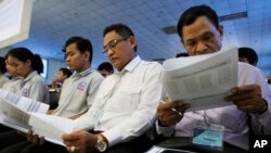 Teachers and students participate in a campaign by the National Election Committee, NEC, in Phnom Penh, Cambodia, Wednesday, May 9, 2018. (AP Photo/Heng Sinith)