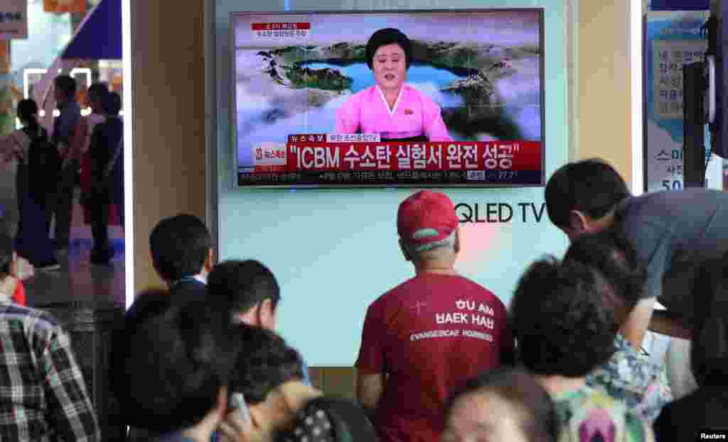 한국 서울역에서 시민들이 북한의 ICBM 수소탄 실험 성공 소식을 보도하는 TV 뉴스를 시청하고 있다.