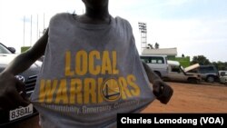 A fan shows off his T-shirt, donated by NBA champs the Golden State Warriors, at the inaugural Manute Bol basketball tournament in Juba, South Sudan.