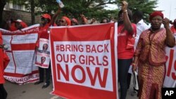 People attend a demonstration calling on the government to rescue the kidnapped girls of the government secondary school in Chibok, in Abuja, Nigeria, Oct. 14, 2014. 