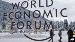 The logo of the World Economic Forum is visible through a window at the congress center where the annual meeting will take place in Davos, Switzerland, Jan. 15, 2017. 