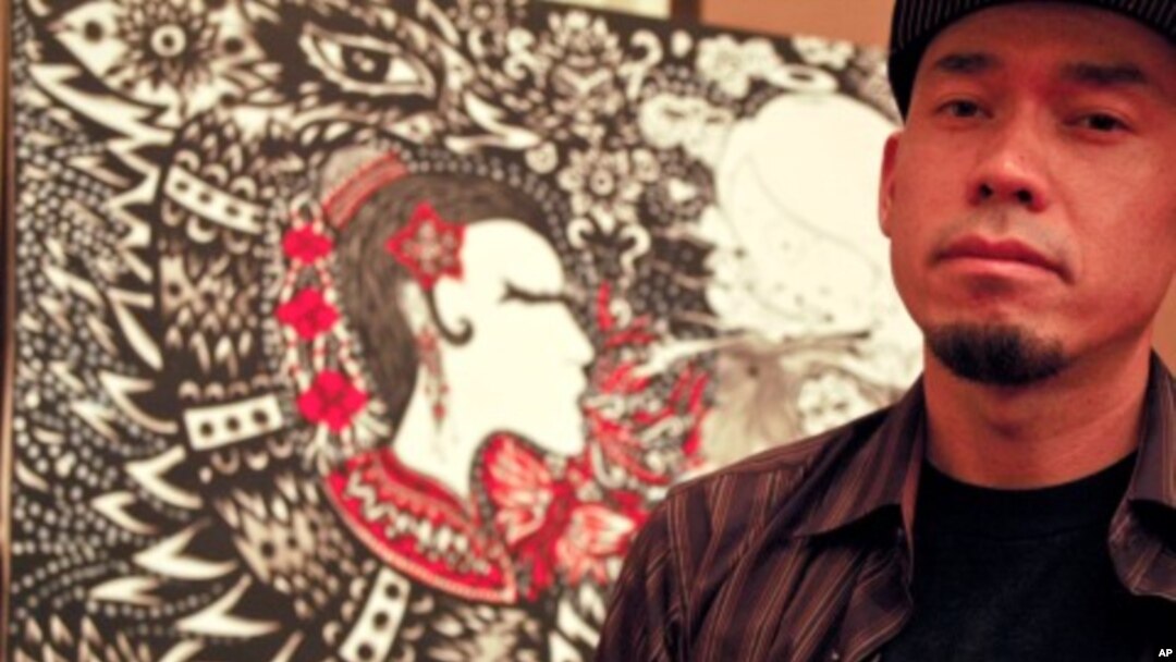 Peap Tarr stands in front of a painting he has up for sale as part of Cambodia's first high-level auction, which took place on March 11, 2012.
