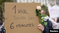 A demonstrator holds a sign at a protest in support of rape victims and Gisele Pelicot, who was allegedly drugged and raped by men solicited by her husband, in Paris, France, Sept. 14, 2024. Sign reads, "One rape every 6 minutes."