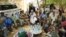 A delegation of Malian, French and UN army officers greet separatist rebel patriarch Intallah Ag Attaher (C, in white) in Kidal, June 23, 2013.