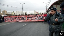 About 7,000 Russian nationalists marched, waving Czarist flags, and chanting such anti-immigrant slogans as 'Migrants Today, Occupiers Tomorrow,' in Moscow, November 4, 2011.