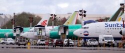 FILE - Boeing 737 Max aircraft are parked at the airport adjacent to a Boeing Co. production facility in Renton, Washington, April 8, 2019.