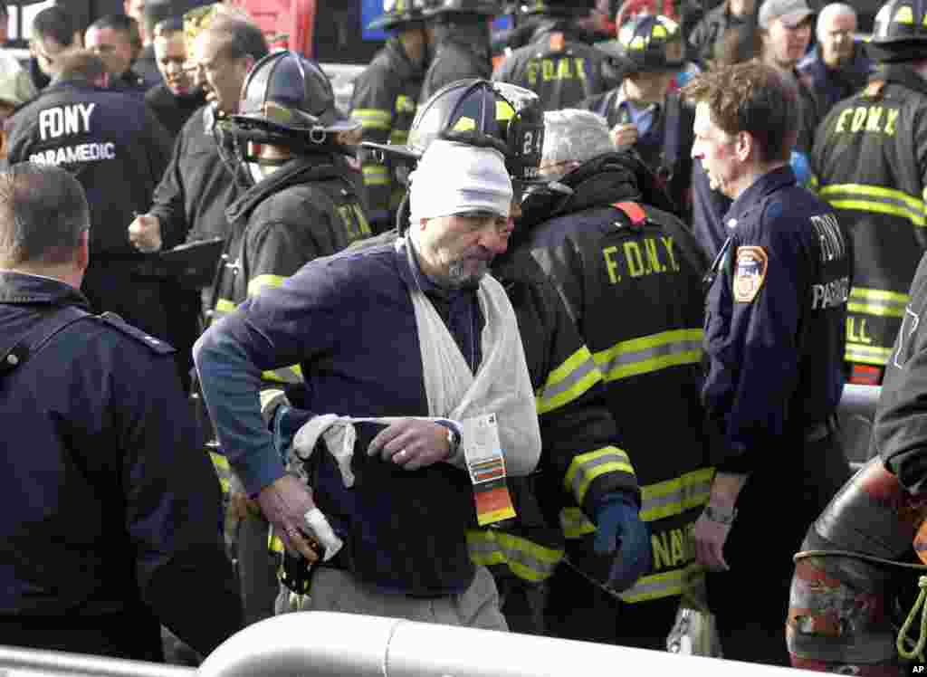An injured passenger of the Seastreak Wall Street ferry is aided by firefighters, New York, January 9, 2013.