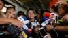 Maria Ressa, center, the award-winning head of a Philippine online news site Rappler, talks to reporters after posting bail at a Regional Trial Court following an overnight arrest by National Bureau of Investigation agents on a libel case Thursday, Feb. 14, 2019 in Manila. 