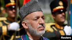 Afghan President Hamid Karzai attends an event to commemorate Afghanistan's 95th anniversary of independence in Kabul, Aug. 19, 2014.