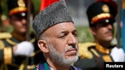 Afghan President Hamid Karzai attends an event to commemorate Afghanistan's 95th anniversary of independence in Kabul, Aug. 19, 2014.