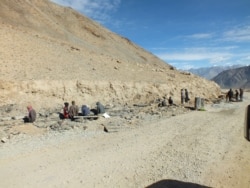 Constriction workers are seen working in North Pullu, Khardung La, on a road site in Leh, India.