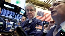 Trader Daniel Krieger, center, works on the floor of the New York Stock Exchange, Feb. 1, 2017.