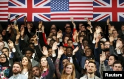 Students raise their hands to ask a question as U.S. President Barack Obama holds a town hall at the Royal Agricultural Halls in London, April 23, 2016.
