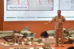 Saudi Colonel Turki al-Malki displays pieces of what he said were Iranian cruise missiles and drones recovered from the attack site that targeted Saudi Aramco's facilities, during a press conference in Riyadh, Sept. 18, 2019.