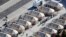 FILE - Immigrant children housed in a tent encampment under the zero tolerance policy by the Trump administration are shown walking in single file at the facility near the Mexican border in Tornillo, Texas, June 19, 2018.