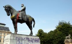 A statue of Belgium's King Leopold II is smeared with red paint and graffiti in Brussels, June 10, 2020. King Leopold II is now increasingly seen as a stain on the nation.