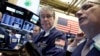 Trader Daniel Krieger, center, works on the floor of the New York Stock Exchange, Feb. 1, 2017.