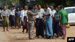 A prison official checks documents before a group of regular prisoners are freed from Insein prison in Yangon, April 8, 2016.