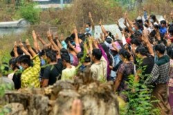 Mourners make the three-finger salute while attending the funeral of Arkar Thu Aung, a protester who was shot dead by security forces in the northwestern town of Kale, April 8, 2021. (Anonymous Souce via Facebook)