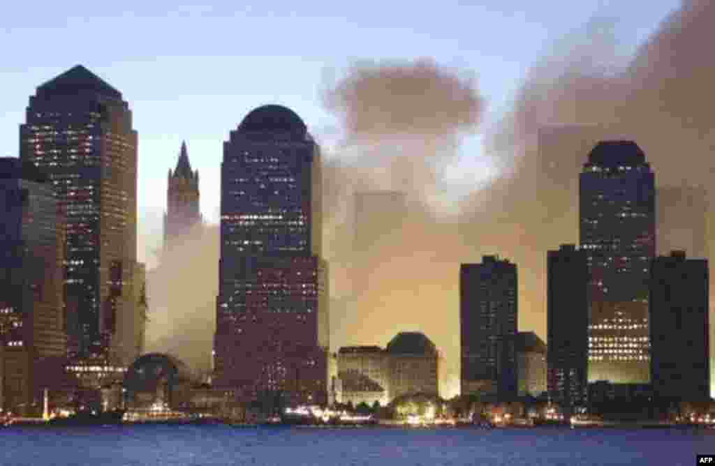 As dawn breaks over New York, smoke rises from lower Manhattan following the destruction of buildings at the World Trade Center in New York, Wednesday, Sept. 12, 2001. Two hijacked commercial aircraft crashed into the center's towers, which were previous