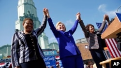 Democratic presidential candidate Hillary Clinton, center, celebrates at a rally with Rep. Karen Bass, D-Calif., left, and Rep. Maxine Waters, D-Calif., Monday, June 6, 2016.
