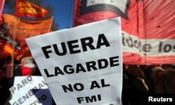 A sign that reads "(Christine) Lagarde, get out - No to the IMF (International Monetary Fund)" is seen during a protest against the G-20 meeting of finance ministers in Buenos Aires, Argentina, July 21, 2018.