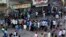 Indians line up without maintaining physical distance to buy liquor outside one of the liquor shops which reopened Monday after six weeks lockdown on the outskirts of Mumbai, India, May 4, 2020. 
