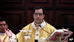 FILE - San Salvador's Archbishop Jose Luis Escobar Alas celebrates Mass at the Metropolitan Cathedral in San Salvador, El Salvador, Jan. 8, 2012. 