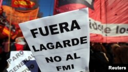 A sign that reads "(Christine) Lagarde, get out - No to the IMF (International Monetary Fund)" is seen during a protest against the G-20 meeting of finance ministers in Buenos Aires, Argentina, July 21, 2018.