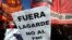 A sign that reads "(Christine) Lagarde, get out - No to the IMF (International Monetary Fund)" is seen during a protest against the G-20 meeting of finance ministers in Buenos Aires, Argentina, July 21, 2018.