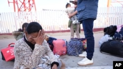 FILE - Maria Mercado, from Colombia but who arrived from Ecuador, gets emotional as she sees that her 1 p.m. appointment was canceled, as she and her family wait at the border crossing in Mexico, Jan. 20. 2025. 