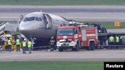 Members of emergency services and investigators work at the scene of an incident involving an Aeroflot Sukhoi Superjet 100 passenger plane at Moscow's Sheremetyevo airport, Russia, May 6, 2019.