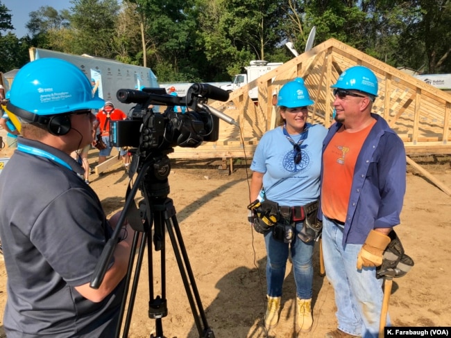 Country music icons Garth Brooks and Trisha Yearwood are just two volunteers among hundreds in what is a massive volunteer effort on the outskirts of South Bend, Ind., to build nearly two dozen homes.