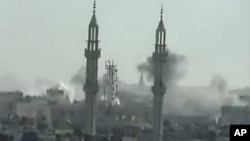 Image taken from YouTube on April 17, 2012, shows smoke rising from reported shelling by Syrian government forces on the district of Khalidiya in the flashpoint central city of Homs