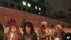 Relatives and supporters of people detained in opposition protests following Sunday's presidential elections in Belarus hold a vigil outside a prison in the capital, Minsk, 21 Dec 2010