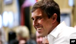 Former Texas congressman Beto O'Rourke smiles as he is introduced during a campaign stop at a brewery in Conway, N.H., March 20, 2019.