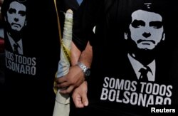 FILE - Supporters of presidential candidate Jair Bolsonaro attend a rally for vice presidential candidate Hamilton Mourao in Manaus, Amazonas state, Brazil, Sept. 15, 2018.