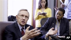 Senate Majority Leader Harry Reid (D-Nevada) gestures while speaking with reporters on Capitol Hill in Washington, April 8, 2011, to discuss the budget impasse.