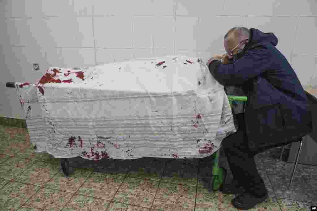 Serhii, father of teenager Iliya, cries on his son&#39;s lifeless body lying on a stretcher at a maternity hospital converted into a medical ward in Mariupol, Ukraine, March 2, 2022.