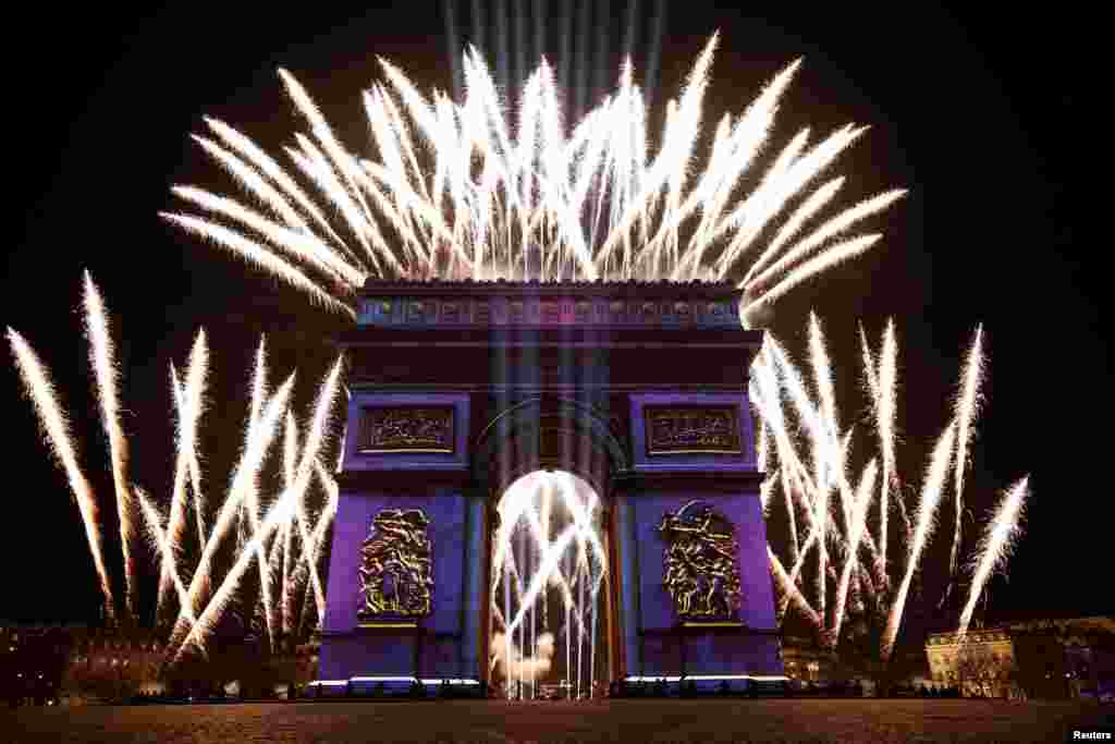 Fireworks illuminate the sky over the Arc de Triomphe during the New Year's celebrations on the Champs Elysees in Paris, France, Dec. 31, 2019.